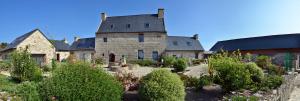 a large stone house with a garden in front of it at Domaine de Kerzuat in Plouarzel