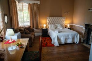 a bedroom with a bed and a living room at Heidelberg Guesthouse in Heidelberg