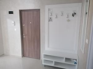 a room with a door and a dresser with a mirror at Promenada 1-4 in Mamaia Sat/Năvodari +18 photos