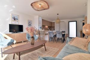 a living room with a couch and a table at Cancale à la plage - Maison avec terrasse pour 6 in Cancale
