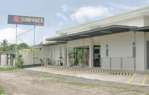 a sun damage gas station with a sign on it at Sundance Tourist Inn in Makar
