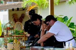 a group of people standing around a table with food at Wild Cottages Elephant Sanctuary Resort in Bophut  +205 photos