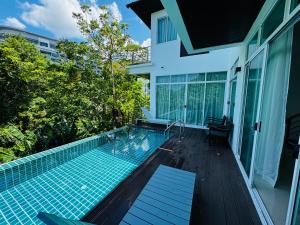 a swimming pool in the backyard of a house at Seaview Prima Villa Karon beach in Karon Beach