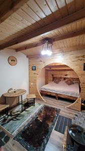 a bedroom with a bed in a wooden room at Jashylkent House in Vorontsovskoye