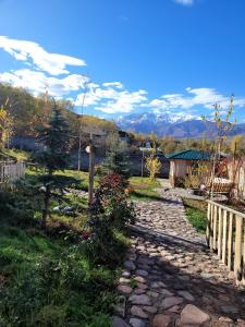 a stone path leading to a house with a fence at Jashylkent House in Vorontsovskoye