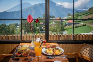 a table with a plate of food and drinks on it at The Dewi Eco Bamboo Villa in Kubupenlokan +83 photos