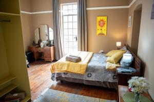 a bedroom with a bed and a large window at Heidelberg Guesthouse in Heidelberg