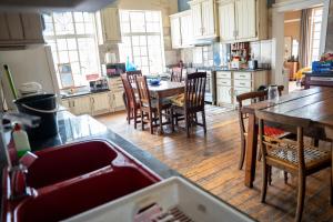 a kitchen with a table and chairs in it at Heidelberg Guesthouse in Heidelberg