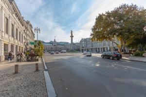 a street in a city with a large building at Cozy Baity Tbilisi in Tbilisi City