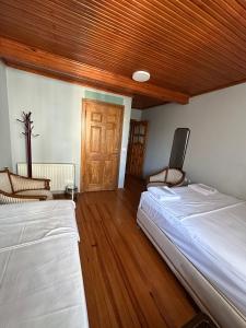 a bedroom with two beds and a wooden ceiling at WOODEN House ÜSKÜDAR in Istanbul