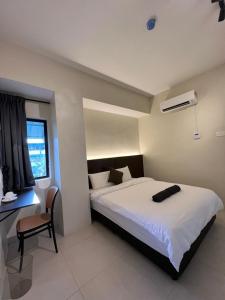 Postel nebo postele na pokoji v ubytování Hotel dan Restoran Seri Kangsar