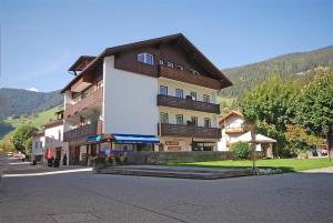 a large building in the middle of a street at Krautgasser Appartements in San Candido