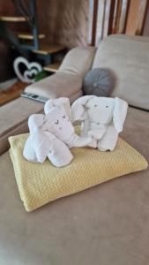 a group of three stuffed elephants sitting on a bed at Villa Melani **** in Oriovac +43 photos
