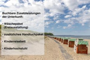 una fila di capanne sulla spiaggia di sabbia di Ferienwohnung Sonnensegler Wohnung 220 a Baabe Altre 16 foto