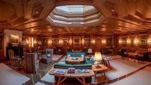 a large room with wooden ceilings and tables and chairs at Post Lech Arlberg in Lech am Arlberg