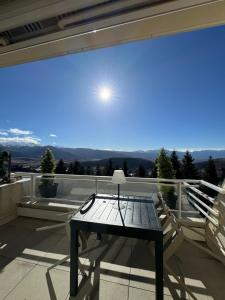 a glass table on the balcony of a house at Le Petit Chalet du Belvédère in Font Romeu Odeillo Via