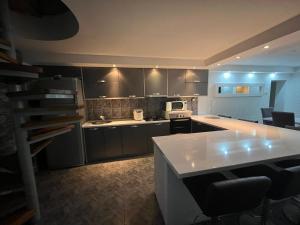 a kitchen with a white counter top and a microwave at GuestHouse Marko Belišće in Belišće