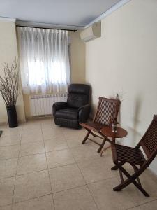 a living room with a leather chair and a table at Chalet en la almadrava in Denia