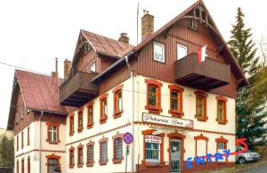 a large building with a red roof at Izery Apartamenty in Szklarska Poręba