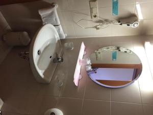 a bathroom with a toilet and a sink and a mirror at Hotel Bachmann in Villabassa +17 photos