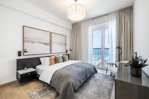 Un dormitorio con una cama y una ventana grande. en 1BR Le Pont B1 Sea View, en Dubái