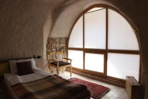 Postel nebo postele na pokoji v ubytování Pinhan Cave Suites