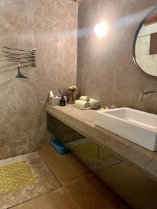 a bathroom with a sink and a tub and a mirror at Casa do Bairro da Veiga in Pereiro