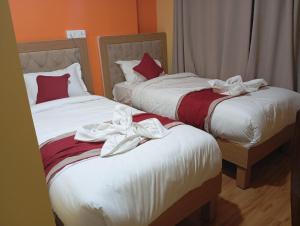 Rúm í herbergi á Rambler's Hotel