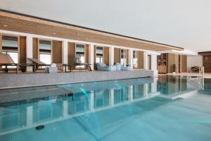 a large swimming pool in front of a building at Hotel Sonne Post mit Schwimmbad in Titisee-Neustadt
