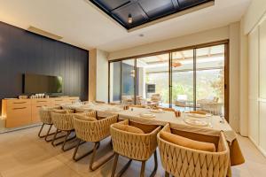 a large dining room with a long table and chairs at Keptur Hotel in Dosemealti
