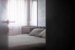 a bedroom with a bed and a window at Lux Apartments in Pristina