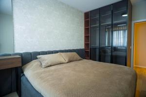 a bedroom with a bed with a pillow on it at Lux Apartments in Pristina