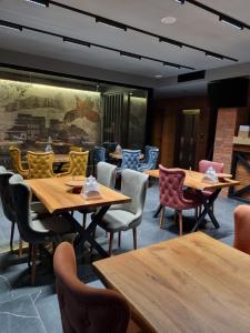 a dining room with wooden tables and chairs at Tsalamuri Old Tbilisi in Tbilisi City