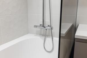 a shower with a shower head in a bathroom at Parkside Lux - 2 bedrooms Apartment, New in Tallinn +39 photos