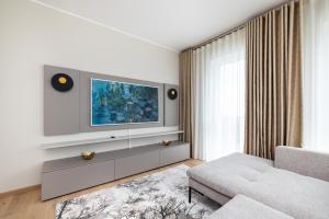a living room with a tv and a couch at Parkside Lux - 2 bedrooms Apartment, New in Tallinn