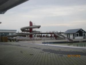 a slide in a playground with a water slide at Ellie-Ferienhaus Strandräuber - VS1 in Dorum-Neufeld