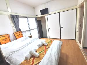 Postel nebo postele na pokoji v ubytování オレンジハウス