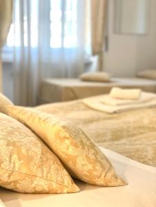 two pillows sitting on top of two beds at Cavour16 rent bedrooms in Genova