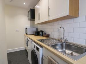 a kitchen with a sink and a counter top at West Morton Suite in Thornhill +4 photos