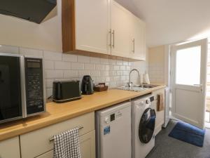 a kitchen with a microwave oven and a dishwasher at West Morton Suite in Thornhill