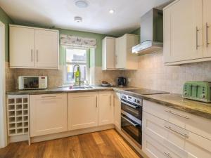 a kitchen with white cabinets and a counter top at The Suite in Thornhill