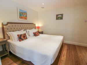 a bedroom with a large white bed with two pillows at The Suite in Thornhill