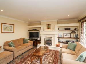 a living room with two couches and a fireplace at Rokeby in Bamburgh