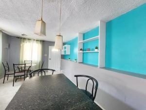 a dining room with blue walls and a table and chairs at Paradise Retreat in Boscobel