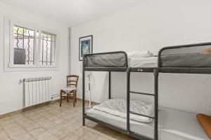 a room with two bunk beds and a chair at La mer in Bormes-les-Mimosas