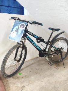 a bike parked next to a wall with a sign on it at Kwa Mzungu Villa in Nungwi