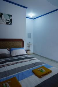 a bedroom with a bed with two towels on it at Asni Homestay Borobudur in Borobudur