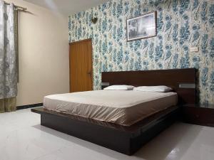 a bedroom with a bed with blue wallpaper at 6Bedroom Villa DHA Lahore in Lahore