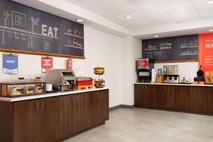 a fast food restaurant with wooden cabinets and a chalkboard at Hampton Inn Spring Lake Fayetteville in Spring Lake