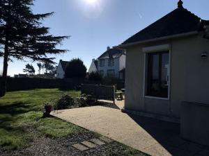 a house with the sun shining in the sky at Kermaria, maison bord de mer in Saint-Brieuc